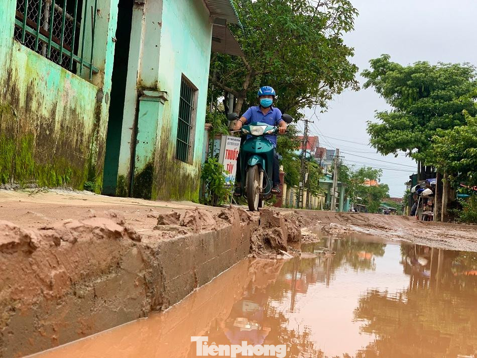 Người dân buộc phải leo xe máy lên lề đường để đi. Ảnh: Nguyễn Ngọc