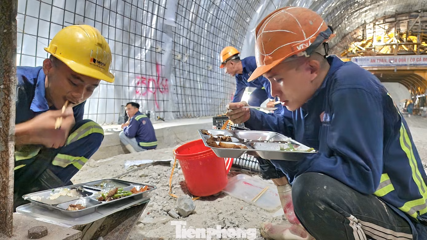Các công nhân ăn vội bữa cơm trưa trong hầm số 3.