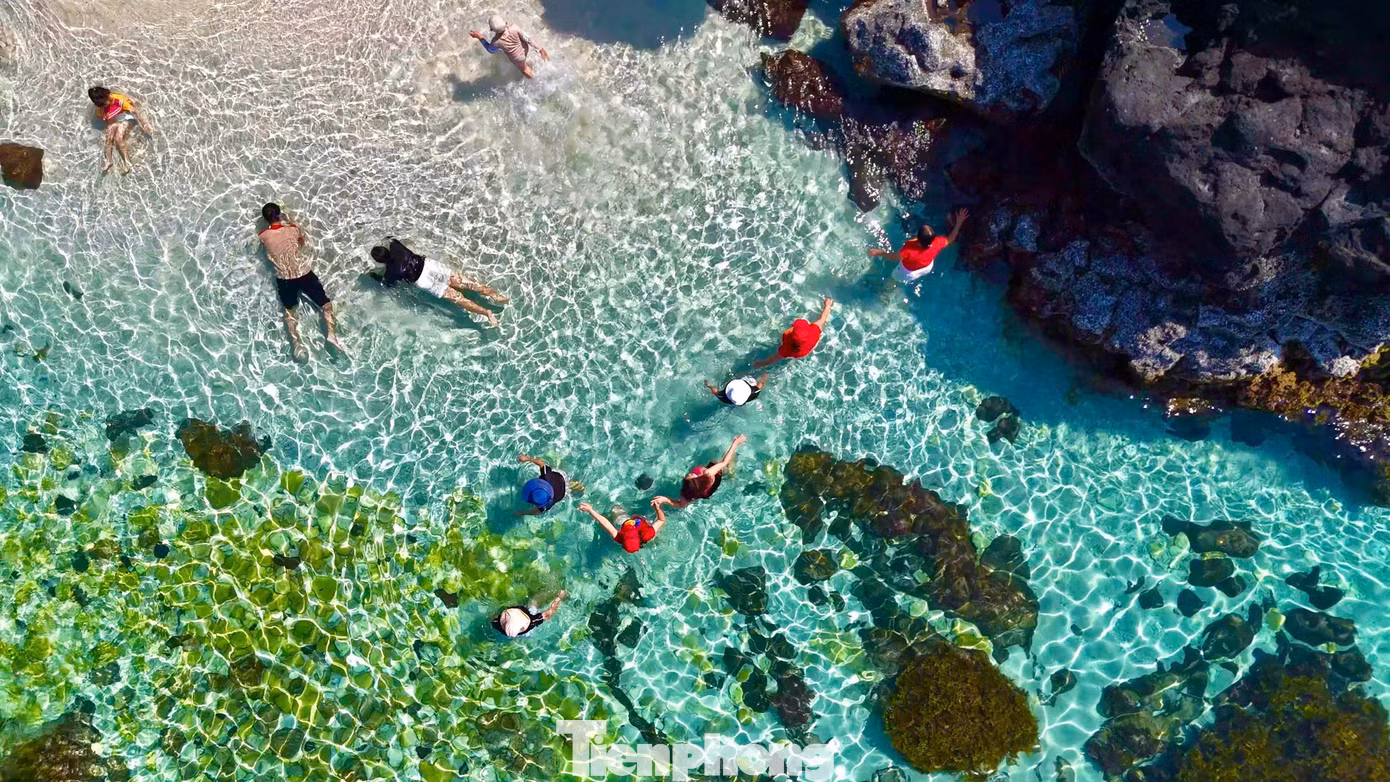 Du khách thích thú bơi lặn giữa làn nước biển trong xanh. Ảnh: Nguyễn Ngọc.