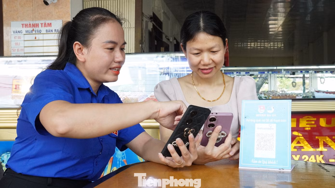 Các bạn đoàn viên thanh niên hướng dẫn người dân cập nhật các ứng dụng của ngân hàng để thanh toán trực tuyến.