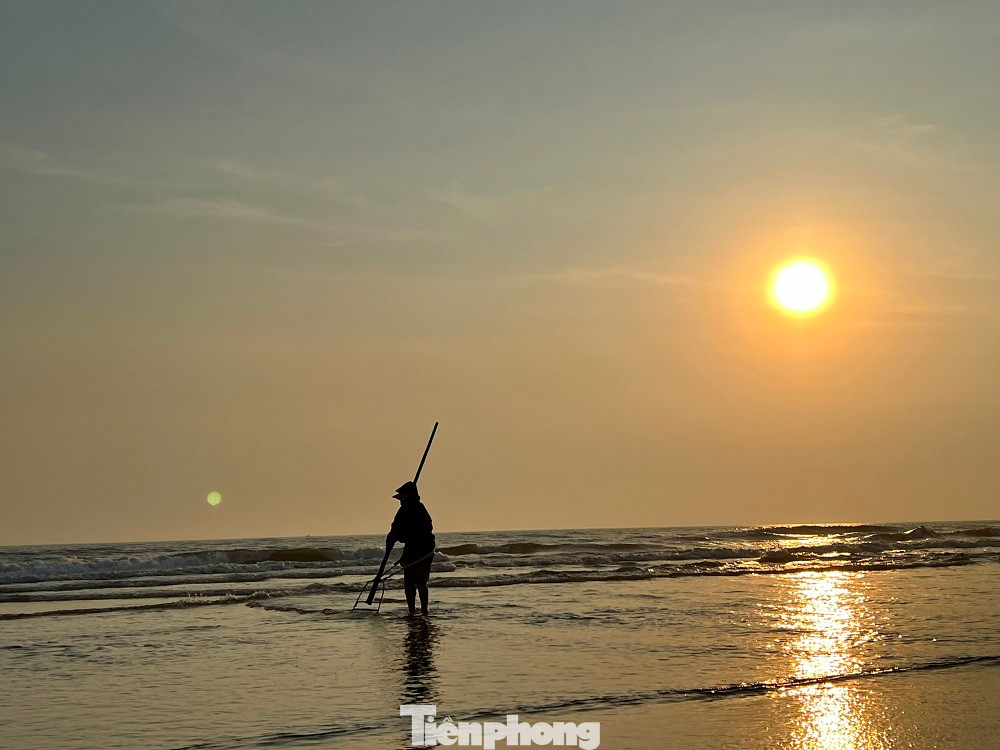 Rạng sáng khi nước thủy triều rút, trên dọc bãi biển xã Tam Thanh (TP Tam Kỳ, tỉnh Quảng Nam), hàng chục người dân đã í ới rủ nhau ra biển cào ốc ruốc (ốc gạo, ốc lể). Đây là vùng biển bãi ngang, mùa này ốc sinh trưởng, phát triển rất nhiều ở gần bờ.