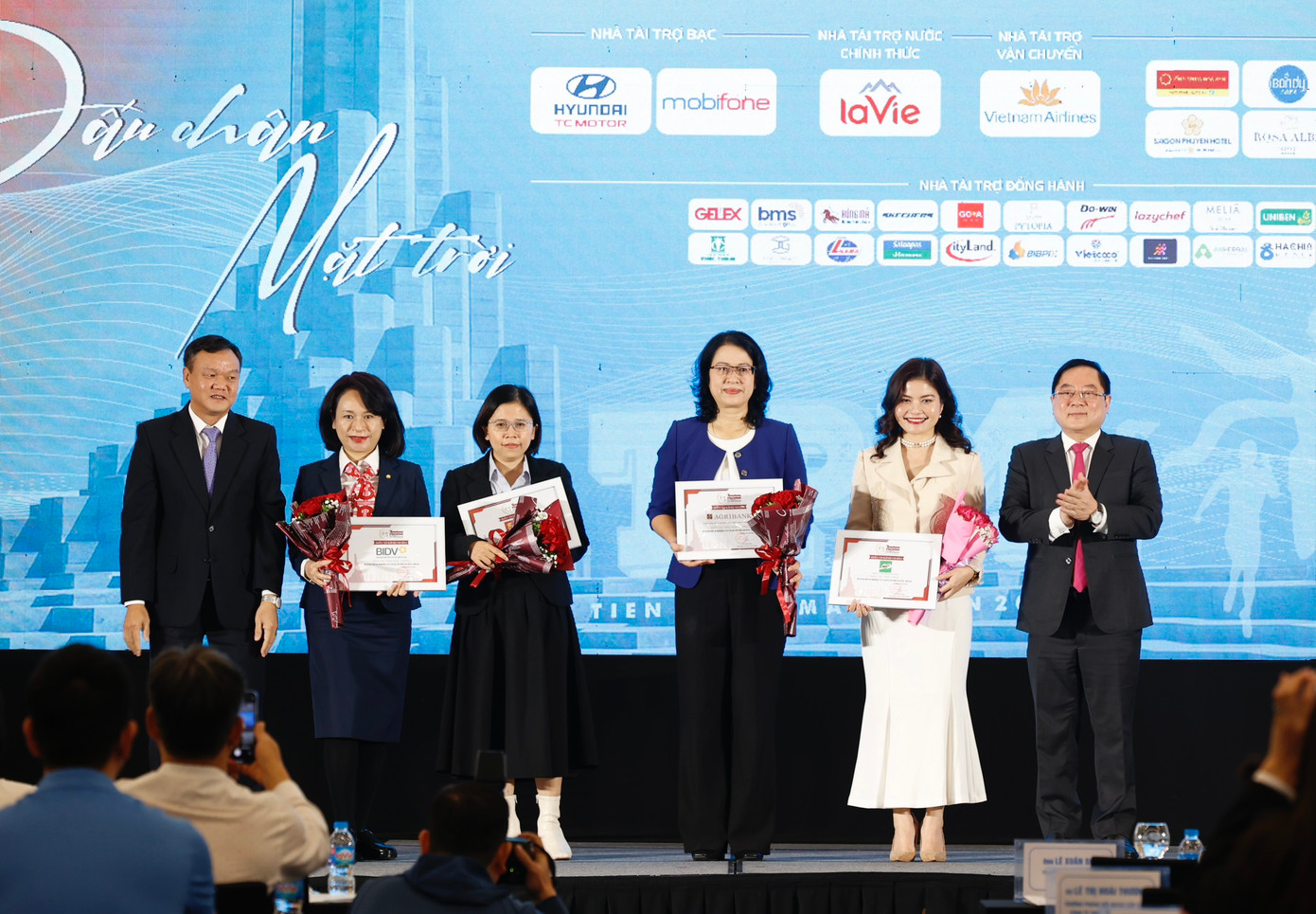 Ông Đào Mỹ - Phó Chủ tịch UBND tỉnh Phú Yên, đồng Trưởng Ban tổ chức Tiền Phong Marathon 2024 (bìa trái) và nhà báo Lê Xuân Sơn - Tổng biên tập báo Tiền Phong, đồng Trưởng Ban tổ chức Tiền Phong Marathon 2024 (bìa phải) trao hoa và chứng nhận tài trợ tặng các nhà tài trợ Kim cương và nhà tài trợ Vàng.