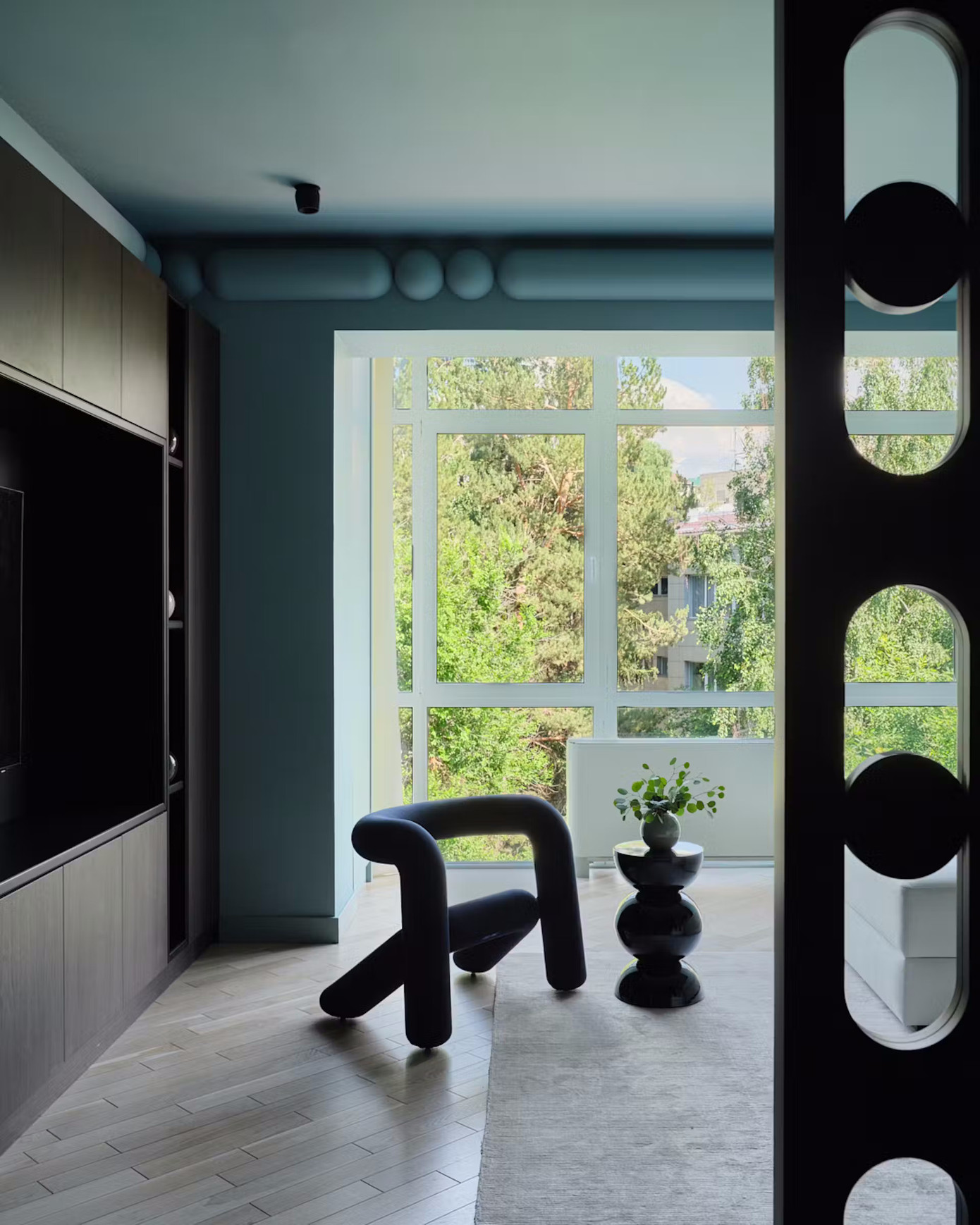 Gia chủ sống một mình, đề cao sự riêng tư và ngăn nắp nên nhịp kiến trúc được tổ chức rành mạch. Phòng khách yên tĩnh mở ra lô gia tích hợp tủ chứa đồ.