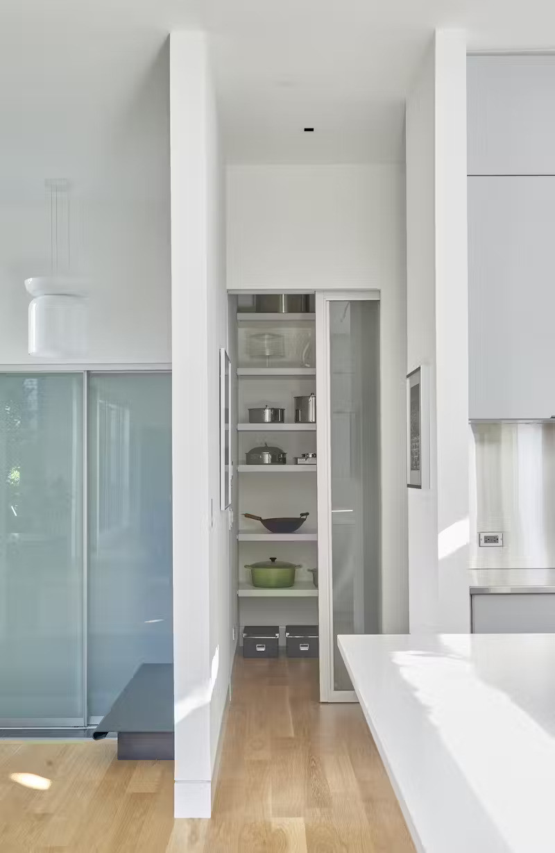 Khu vực để dụng cụ nấu nướng được đặt phía sau bức tường ngăn, tạo sự gọn gàng cho không gian.