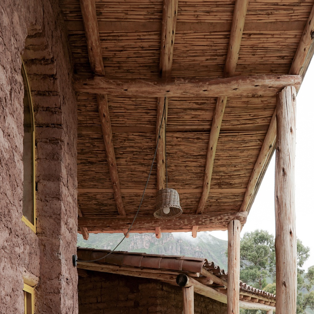 Lấy cảm hứng từ mái nhà Andes truyền thống, hệ mái kép được bố trí phủ lên hai khối nhà chính. Các xà nhà được đặt song song với tuyến đường dẫn ra sông Vilcanota, nằm trên một bức tường đất dày 80cm vừa phân chia không gian, vừa là trụ đỡ cho hai trong ba xà chính.