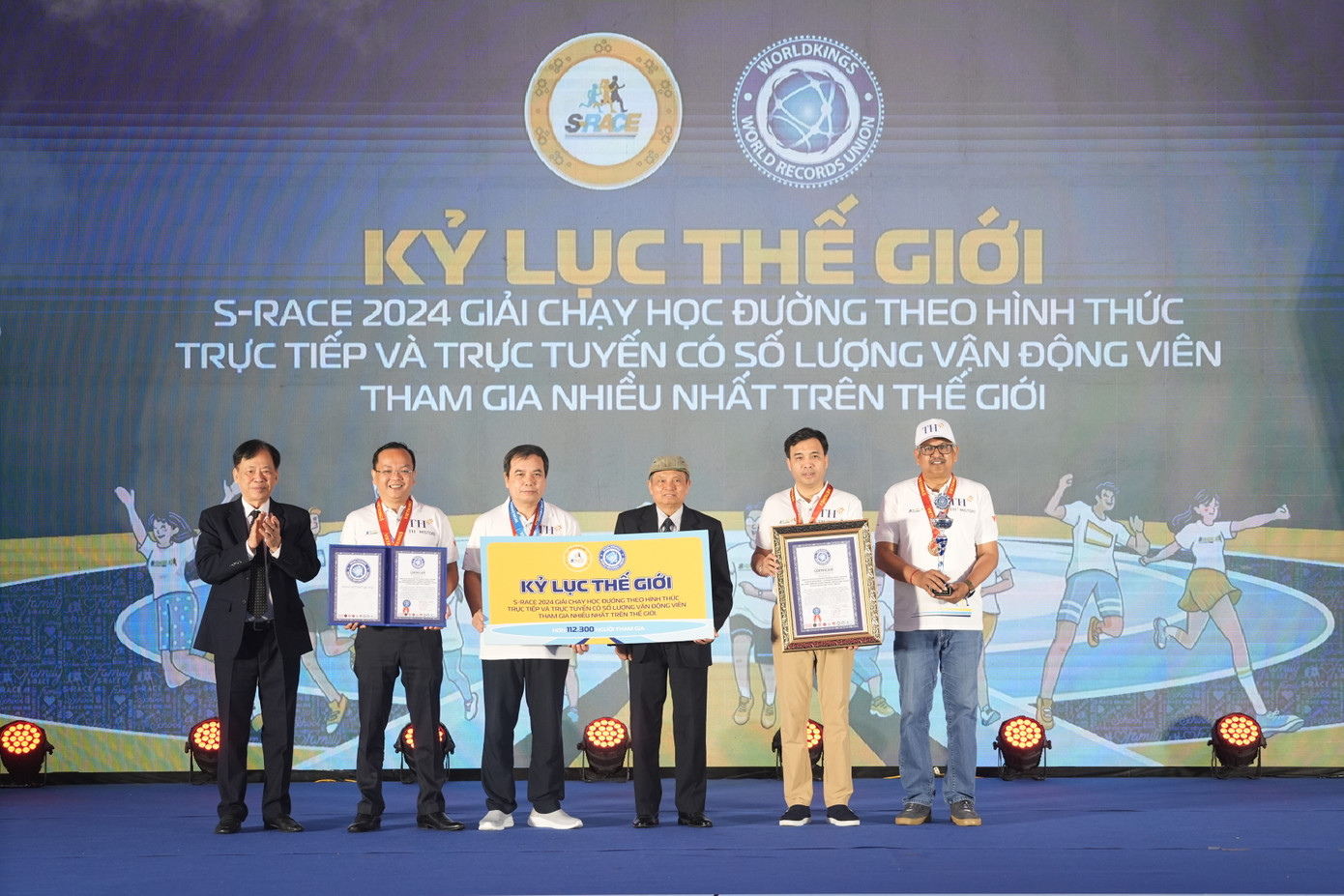 Đại diện Ban Tổ chức S-Race 2024 và Công ty CP Chuỗi Thực phẩm TH đón nhận bằng xác lập Kỷ lục Thế giới, huy hiệu và cúp từ Liên minh Kỷ lục Thế giới. Ảnh BTC