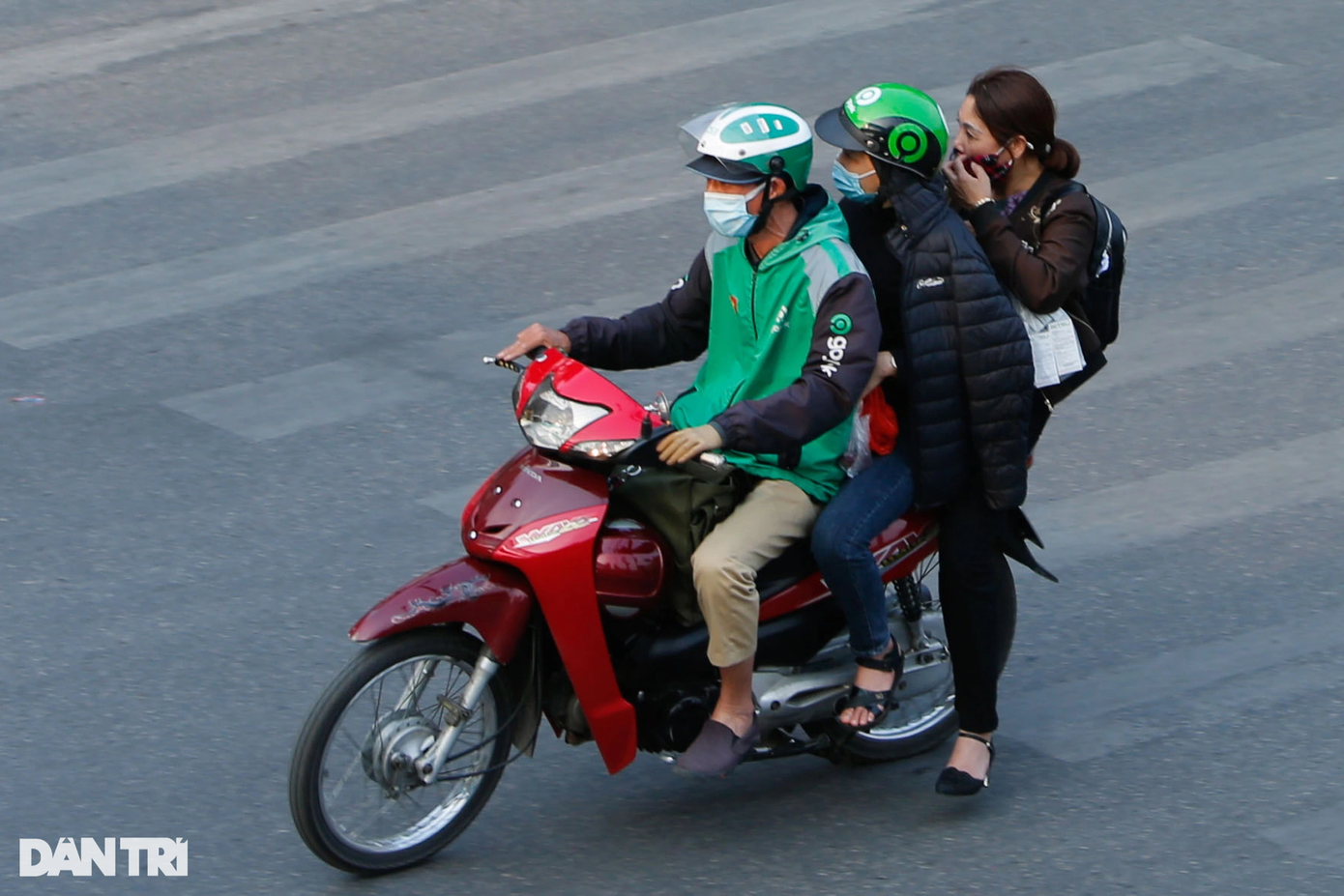 Hai tài xế xe ôm công nghệ Grab và Gojek chở khách quá số người quy định và không đội mũ bảo hiểm trên đường Trần Khát Chân.