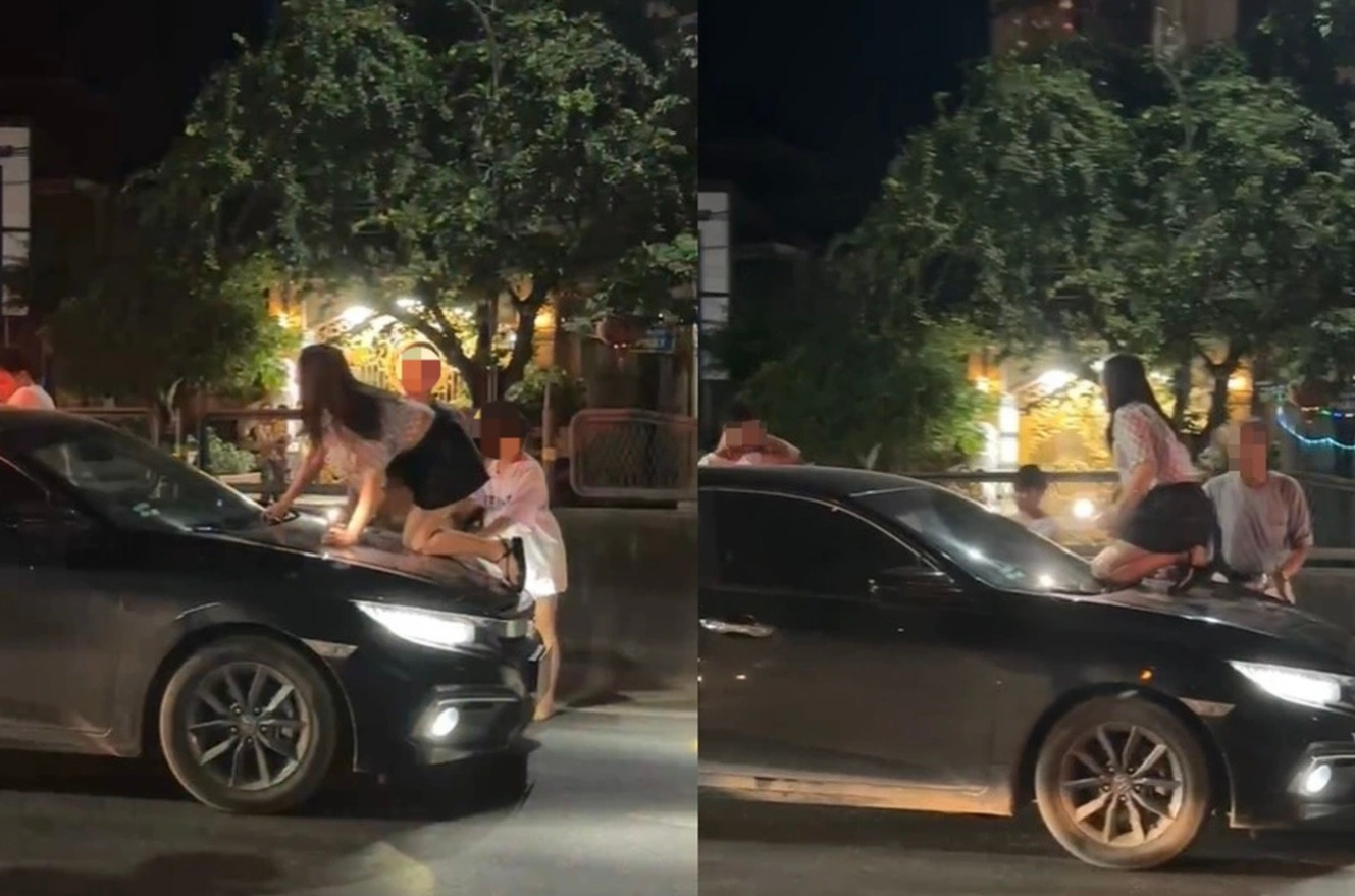 Chị B. trèo trên nắp capo khi phát hiện chồng và nhân tình đi trên xe (ảnh chụp màn hình). Chị B. trèo trên nắp capo khi phát hiện chồng và nhân tình đi trên xe (ảnh chụp màn hình).