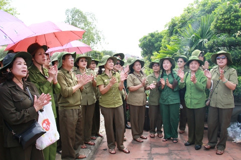 Đoàn đại biểu đứng hát trước Đài tưởng niệm Ga Gôi. Ảnh: Trường Phong 