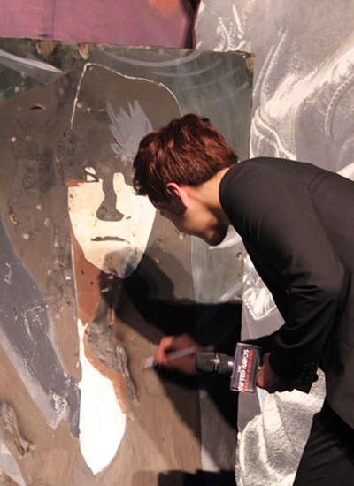 Tài tử xứ Hàn rất bất ngờ với món quà này. Anh ký tặng vào chân dung mình