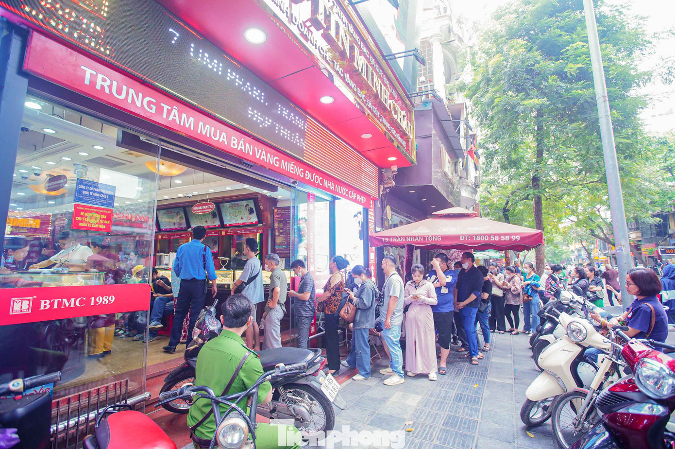 Nhân viên cửa hàng hướng dẫn người dân xếp hàng, tránh tình trạng chen lấn, xô đẩy.