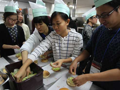 Sinh viên VN tham gia chương trình trải nghiệm thực tế tập làm bánh hamburger tại trung tâm đào tạo..
