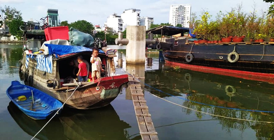 Một gia đình thương hồ ở Đồng bằng sông Cửu Long năm nay quyết định dừng chân đôi ba hôm ở TPHCM để đón Tết. Trên chiếc thuyền nhỏ, bố mẹ của các cháu vẫn làm việc đến tối 30 nên vẫn chưa kịp chuẩn bị gì cho những ngày Tết dù giao thừa đã cận kề. Một gia đình thương hồ ở Đồng bằng sông Cửu Long năm nay quyết định dừng chân đôi ba hôm ở TPHCM để đón Tết. Trên chiếc thuyền nhỏ, bố mẹ của các cháu vẫn làm việc đến tối 30 nên vẫn chưa kịp chuẩn bị gì cho những ngày Tết dù giao thừa đã cận kề.