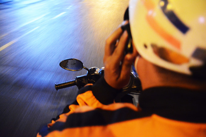 Mỗi người giao hàng đều tìm thấy niềm vui nhỏ trong những chuyến xe đêm để bám trụ với nghề. Ảnh: HOÀI NHÂN.