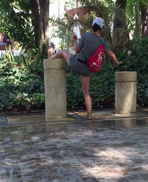 Nữ du khách đứng cạo lông chân và rửa ngay tại vòi nước công cộng là nơi để mọi người tới lấy nước miễn phí.