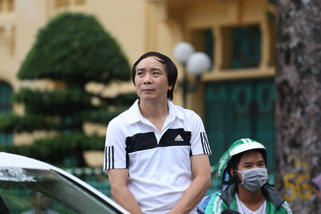 Người đàn ông hướng ánh nhìn về phía đoàn xe linh xa chở linh cữu Chủ tịch nước. (Ảnh: Mai Châm)