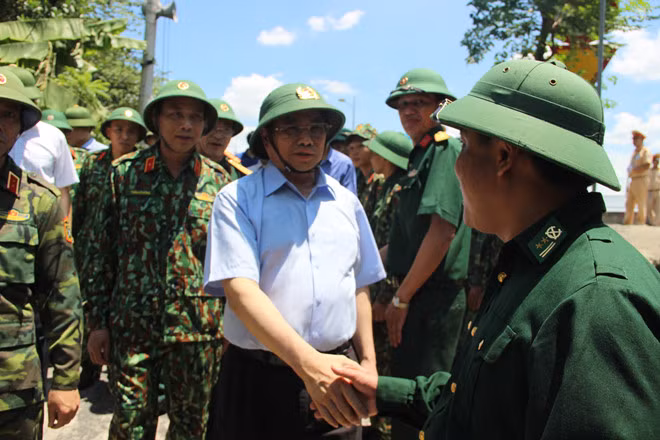 Ông Phạm Minh Chính và ông Vương Đình Huệ (ảnh phải) động viên, tặng quà lực lượng chữa cháy rừng. Ảnh: Phạm Đức - Tân Kỳ