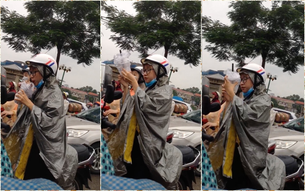 Dù trời mưa nhưng cũng phải uống hết cốc trà sữa cái đã. (Ảnh cắt từ clip) Dù trời mưa nhưng cũng phải uống hết cốc trà sữa cái đã. (Ảnh cắt từ clip)