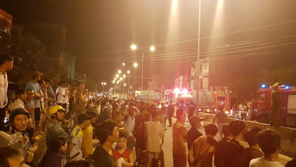 Hàng trăm người dân tập trung theo dõi lực lượng chức năng dập lửa. ẢNH: NGUYỄN CHUNG.