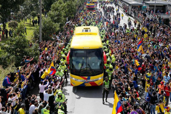 Biển người hâm mộ vẫy cờ, hò reo khi xe buýt chở các tuyển thủ đi qua đường Bogota.