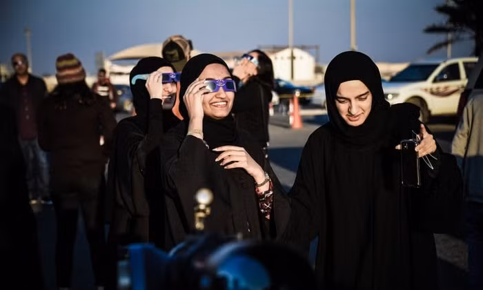 Các cô gái quan sát nhật thực ở Manama, Bahrain. Ảnh: AFP/Getty