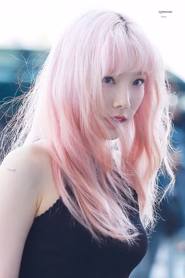 Taeyeon (SNSD) nhuộm tóc khá thường xuyên. Nữ thần tượng thường chọn những tông màu nổi, tôn lên làn da trắng. Màu hồng nữ tính giúp Taeyeon nổi bật hơn khi ra sân bay.