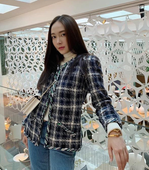 Jessica mặc áo khoác vải tweed kiểu truyền thống. Đây là dáng áo đặc trưng do nhà thiết kế Coco Chanel lăng xê và đến hàng chục năm sau vẫn không lỗi mốt.