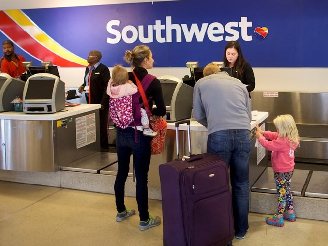 Ngày nay, có rất nhiều thiết bị hỗ trợ cho việc làm thủ tục trước chuyến bay. Ảnh chụp một gia đình đang làm thủ tục check-in tại sân bay quốc tế Philadelphia, Mỹ năm 2018.