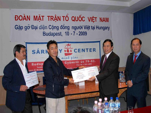 Ông Vũ Trọng Kim (thứ hai từ phải sang) đón nhận khoản tiền quyên góp ủng hộ chương trình “Trái tim cho em”. Ảnh: Trần Lê