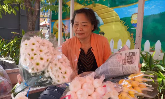 Người dân chuẩn bị hoa trắng tiễn đưa các liệt sĩ được quy tập tại Công viên Lê Thị Riêng 