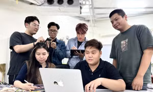 Bạn Duy Đức (ngồi) cùng đồng nghiệp thảo luận về dự án sắp tớiẢnh: PV 