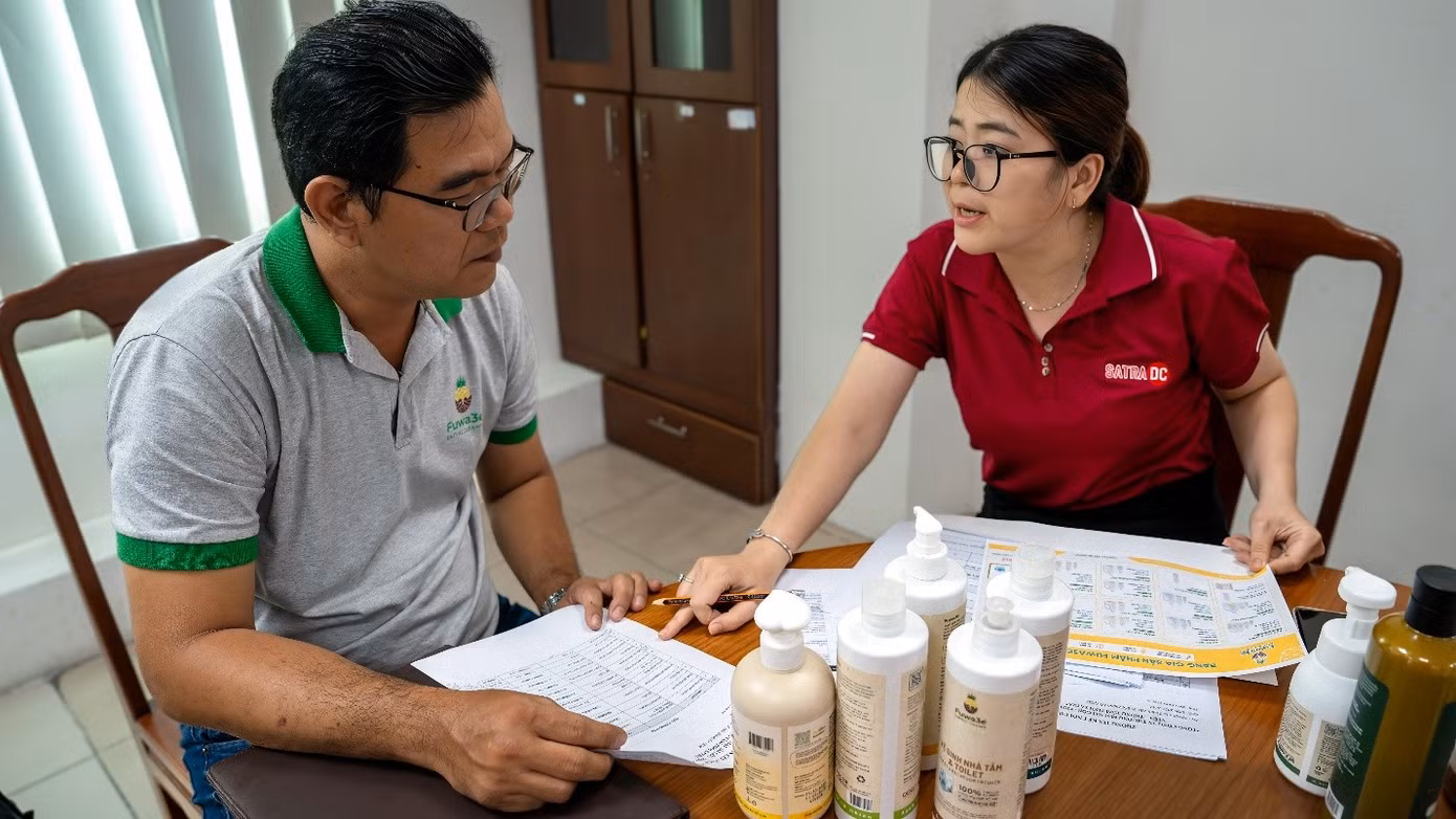 Nhân viên Trung tâm Phân phối SATRA đang hướng dẫn doanh nghiệp các thủ tục cần thiết để đăng ký, đưa hàng vào hệ thống bán lẻ SATRA. Ảnh: SATRA