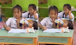 Hình ảnh cô học trò bế em trong lớp học ở Thái Lan. (Ảnh từ clip)