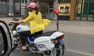 Hình ảnh cô gái mặc thường phục lái xe chuyên dụng của CSGT gây xôn xao cộng đồng mạng.