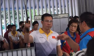 Xạ thủ Hoàng Xuân Vinh khá căng thẳng ngay từ lúc các trọng tài kiểm tra súng trước bài bắn chung kết 50m súng ngắn hơi ảnh HUY HOÀNG