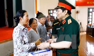 Đại tướng Ngô Xuân Lịch, Ủy viên Bộ Chính trị, Phó Bí thư Quân ủy Trung ương, Bộ trưởng Bộ Quốc phòng thăm hỏi tặng quà các đối tượng chính sách. (Ảnh: An Đăng/TTXVN)