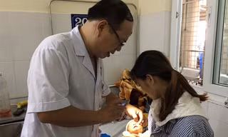 Bác sĩ Hoàng Cương khám mắt cho cháu Đinh Phương Thảo. Ảnh: Đỗ Hợp