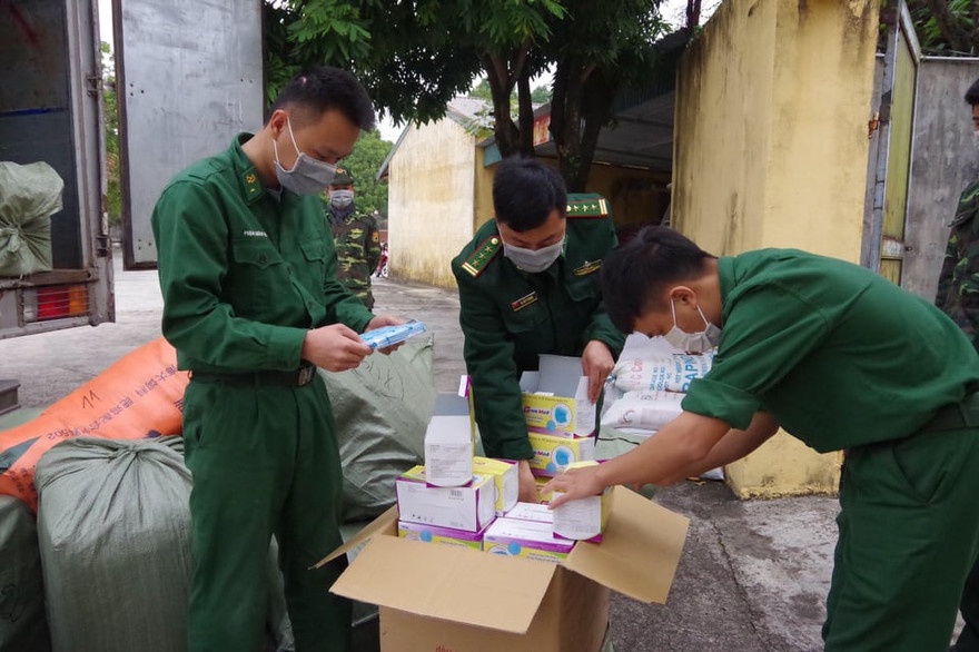 Kiểm đếm số khẩu trang tang vật trong vụ việc.