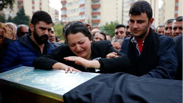 Người thân đau đớn trong lễ tang. Ảnh: BBC