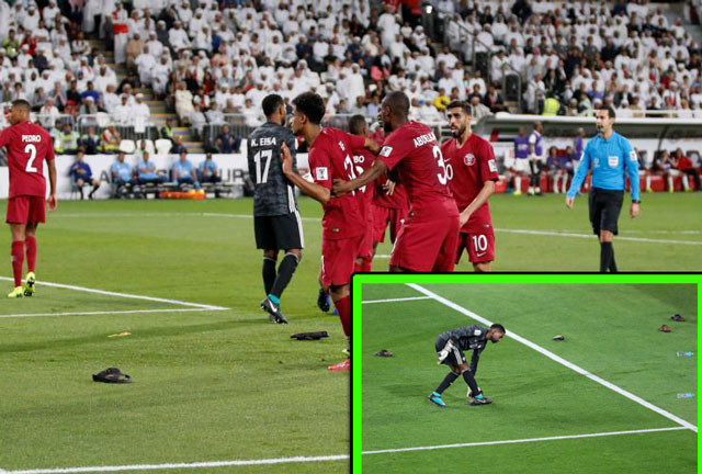 Các cầu thủ Qatar phải hứng "cơn mưa giày" từ những CĐV UAE.