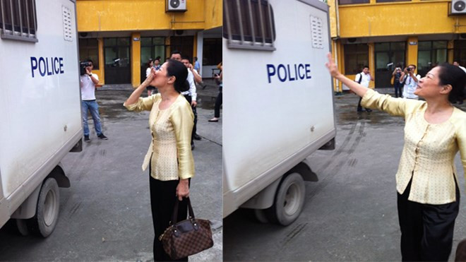 Vợ Dương Chí Dũng tươi cười, hôn gió chồng. Ảnh: Bảo Thắng