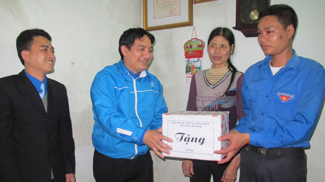 Anh Nguyễn Đắc Vinh tặng quà, động viên anh Long - người có hoàn cảnh khó khăn nhưng luôn đam mê hoạt động đoàn. Ảnh: Phạm Duẩn
