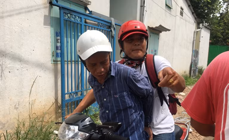 Đối tượng (nón trắng) bị "hiệp sĩ" Hải đưa về trụ sở công an