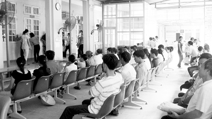 Ngồi chờ đến lượt nộp viện phí tại Bệnh viện Đa khoa Đoan Hùng - Phú Thọ. Ảnh: Trung Kiên