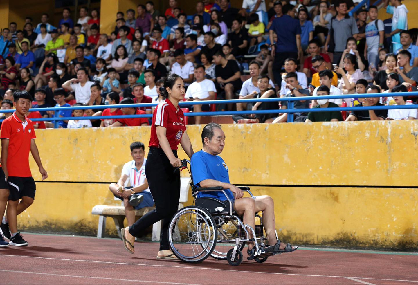 HLV Vương Tiến Dũng ngồi xe lăn đến sân Hàng Đẫy năm 2020. (Ảnh: Thể Công) HLV Vương Tiến Dũng ngồi xe lăn đến sân Hàng Đẫy năm 2020. (Ảnh: Thể Công)