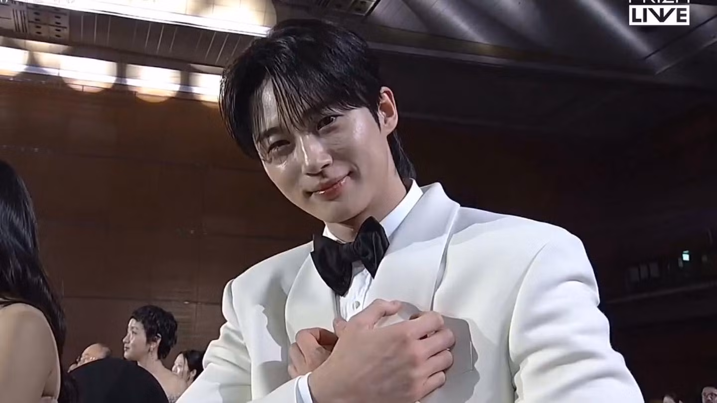 Biểu cảm xúc động của Byeon Woo Seok (nam diễn viên nhận giải Giải thưởng phổ biến Prism cùng Kim Hye Yoon) khi thấy ảnh hồi bé của mình trên màn hình của Baeksang Awards 2025.