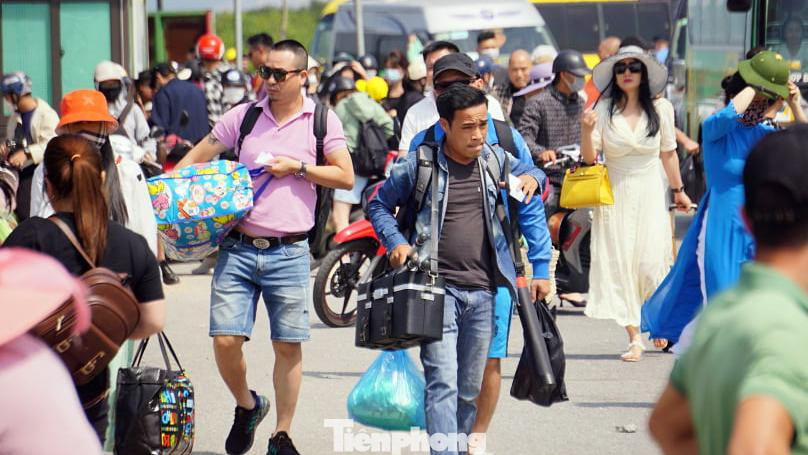 "Giao thông ùn tắc, phương tiện tê liệt trên đường ra phà khiến mọi người mệt mỏi. Nhiều người rời xe buýt, xe khách đi bộ hoặc bắt xe ôm ra phà ngồi nghỉ", anh Tuấn nói.