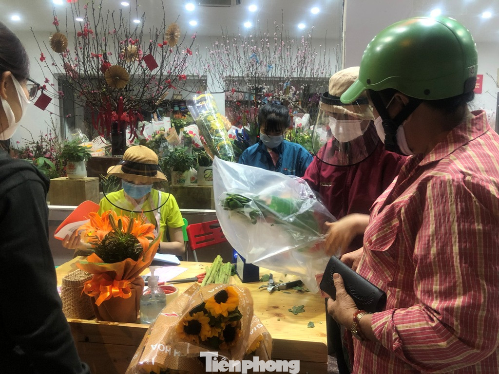 Nhân viên đội mũ chống giọt bắn bán hoa đại hạ giá ở TP.HCM ảnh 6