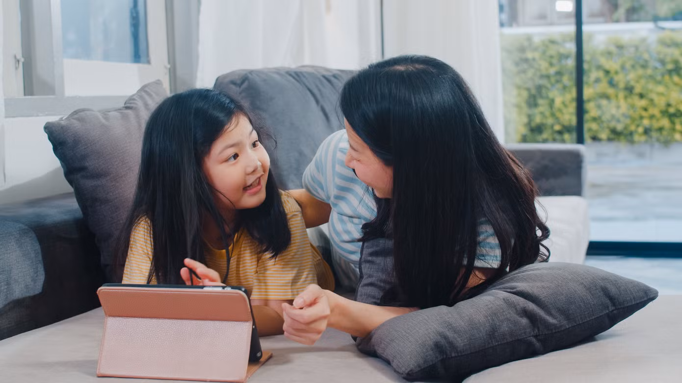 young-asian-family-daughter-happy-using-tablet-home-japanese-mother-relax-with-little-girl-watching-movie-lying-sofa-living-room-house-funny-mom-lovely-child-are-having-fun.jpg