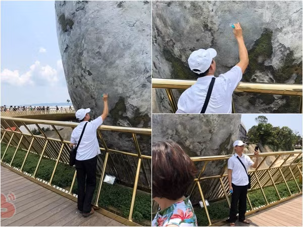 Người đàn ông thản nhiên dùng bút xóa "vẽ bậy" lên bàn tay đá ở Cầu Vàng - Đà Nẵng